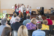 © jollier_ - Children in kindergarten perform on stage. blurry