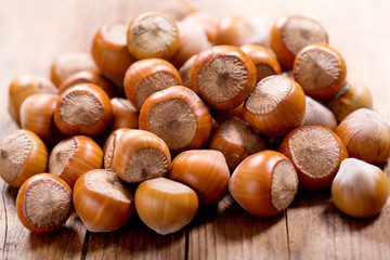 Wall Mural - hazelnuts on a wooden table
