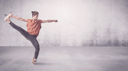 A beautiful young hip hop dancer dancing contemporary urban street dance in empty clear grey wall background concept.