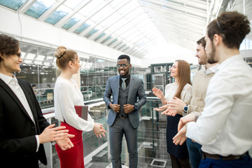 Wall Mural - young business partners applauding to reporter after listening report at seminar