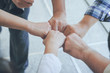 © thithawat - group of diversity multiethnic people hands bump for relationship and together teamwork concept.