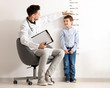 © Africa Studio - Male doctor measuring height of little boy in clinic