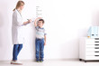© Africa Studio - Female doctor measuring height of little boy in clinic