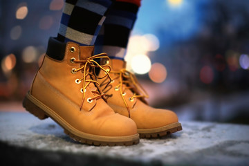 Canvas Print - Young woman in winter shoes on street at night