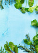 Food background. Various summer green vegetables, spices and fresh herbs on blue concrete background. Copy space, top view flat lay background.