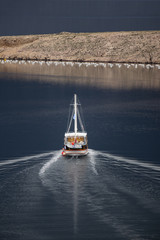 Wooden sailing boat with two masts sail in Maslenica gorge near city Zadar in Croatia