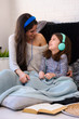© lordn - Girls having fun at home, listening music over smart phone. Family quality time