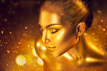 Wall Mural - fashion art golden skin woman portrait closeup. gold, jewelry, accessories. model girl with golden g