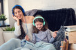 © lordn - Girls having fun at home, listening music over smart phone. Family quality time