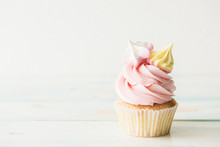 One Cupcake On A Wooden Table. Copy Space
