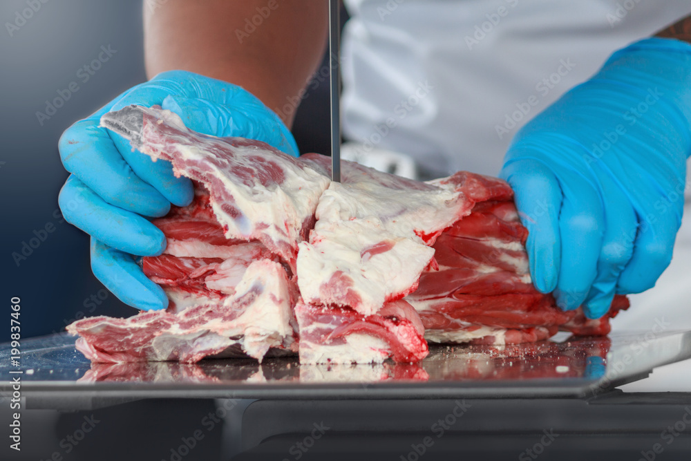 Butcher cutting meat