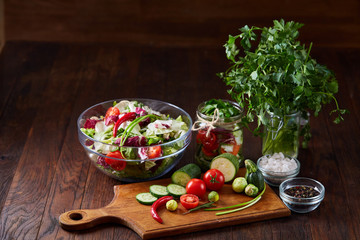 Wall Mural - fresh vegetables on the cutting board over wooden background, selective focus, shallow depth of field