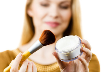 Smiling woman holding make up brush