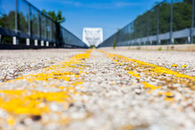 Road With Double Yellow Centerlines Shot In Low Angle Perspective With Shallow Depth Of Field