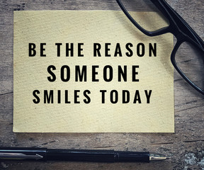 Motivational and inspirational quotes - Be the reason someone smiles today. With blurred styled background.