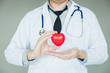© joyfotoliakid - Doctor holding heart on background of Hospital ward