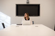 © David Prahl - woman sitting alone in conference room preparing for meeting