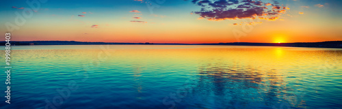 Sunset over the lake. Amazing panorama landscape © Olga Khoroshunova