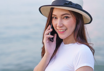 Wall Mural - woman using mobile phone on the sea beach