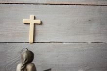 Angel And Cross On Wooden Background