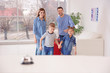 © New Africa - Happy family arriving in hotel