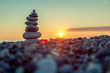 Pyramid of stones on the beach at sunset, beautiful seascape, rest and seaside vacation concept