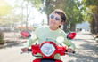 Beautiful mature stylish woman on motobike on a summer day, active pension and travel