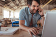 © mavoimages - Woodworker using phone and laptop
