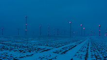 Wind Farm In The Night With A Blue Sky