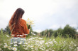 © alexkich - Beautiful girl collects daisies in summer field