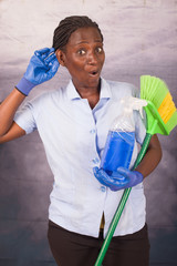 Wall Mural - Young cleaning lady with work tools listening