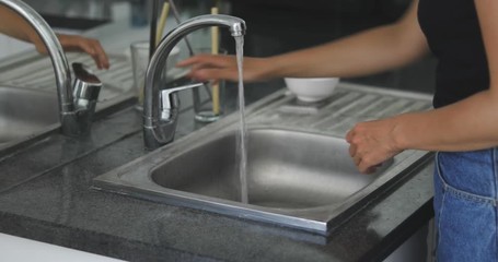 Wall Mural - 4k footage of woman standing on kitchen and washing reusable metal straw. Zero waste concept