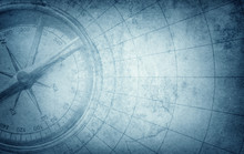 Old Vintage Retro Compass On Ancient Map. Survival, Exploration And Nautical Theme Grunge Blue Background