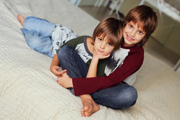 Two happy brothers  having fun together at home. Boys