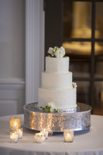 Beautiful Three Tiered Wedding Cake With Candles.