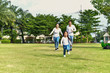 © S photographer - Parents and daughters go for a walk in the park.