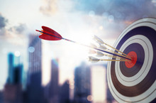 Arrow Hit The Center Of Target With Modern Skyscraper Background. Business Target Achievement Concept. 3D Rendering
