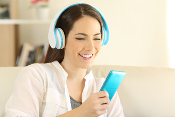 Sticker - Happy teen listening to music using a blue smartphone