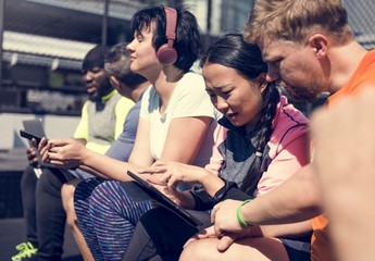 Group of diverse people using digital devices