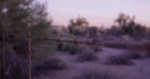 Barbwire Fence In Desert - Panning Shot