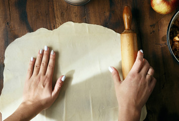 Poster - Female hands roll out dough preparation apple strudel top view