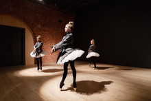 The Ballet Concept. Young Ballerina Girls. Women At The Rehearsal In A White Tutu And A Grey Jacket. Prepare A Theatrical Performance