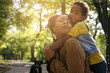© Mladen - African American mother and her daughter enjoying in park together and hugging.