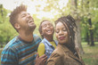 © Mladen - African American parents enjoying with daughter in park and laughing.