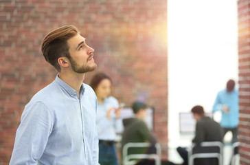 Canvas Print - Young businessman looking away while working in the office.