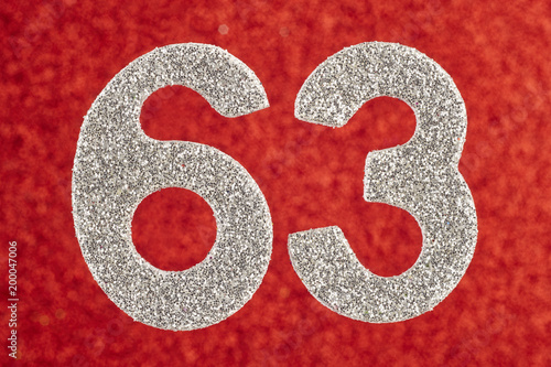 Poster Number sixty-three silver color over a red background