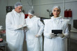 © Wavebreak Media - Technician holding digital tablet at meat factory