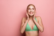 © Yakobchuk Olena - Waist up portrait of fit lady enjoying her holiday. She is posing in swimsuit. Copy space in left side. Isolated on rose background