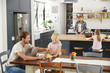 © Monkey Business - Young white family busy in their kitchen, elevated view