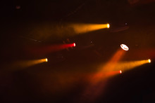Red And Orange Spot Lights With Strong Beams In Smoke